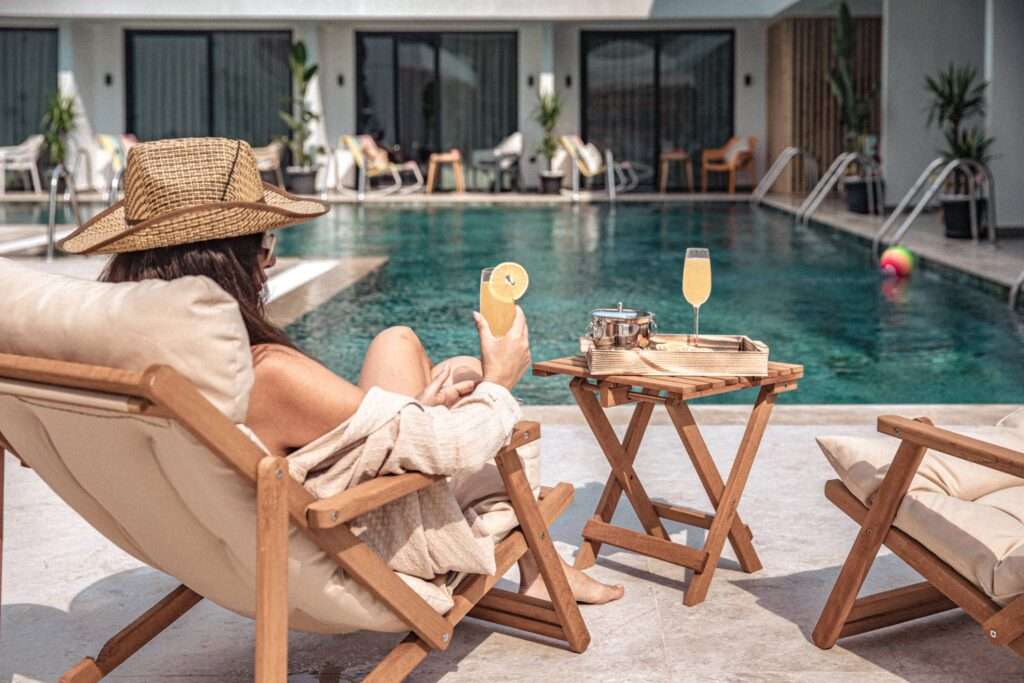 Scape Hotel Fethiye Outside woman with a drink looking at the pool